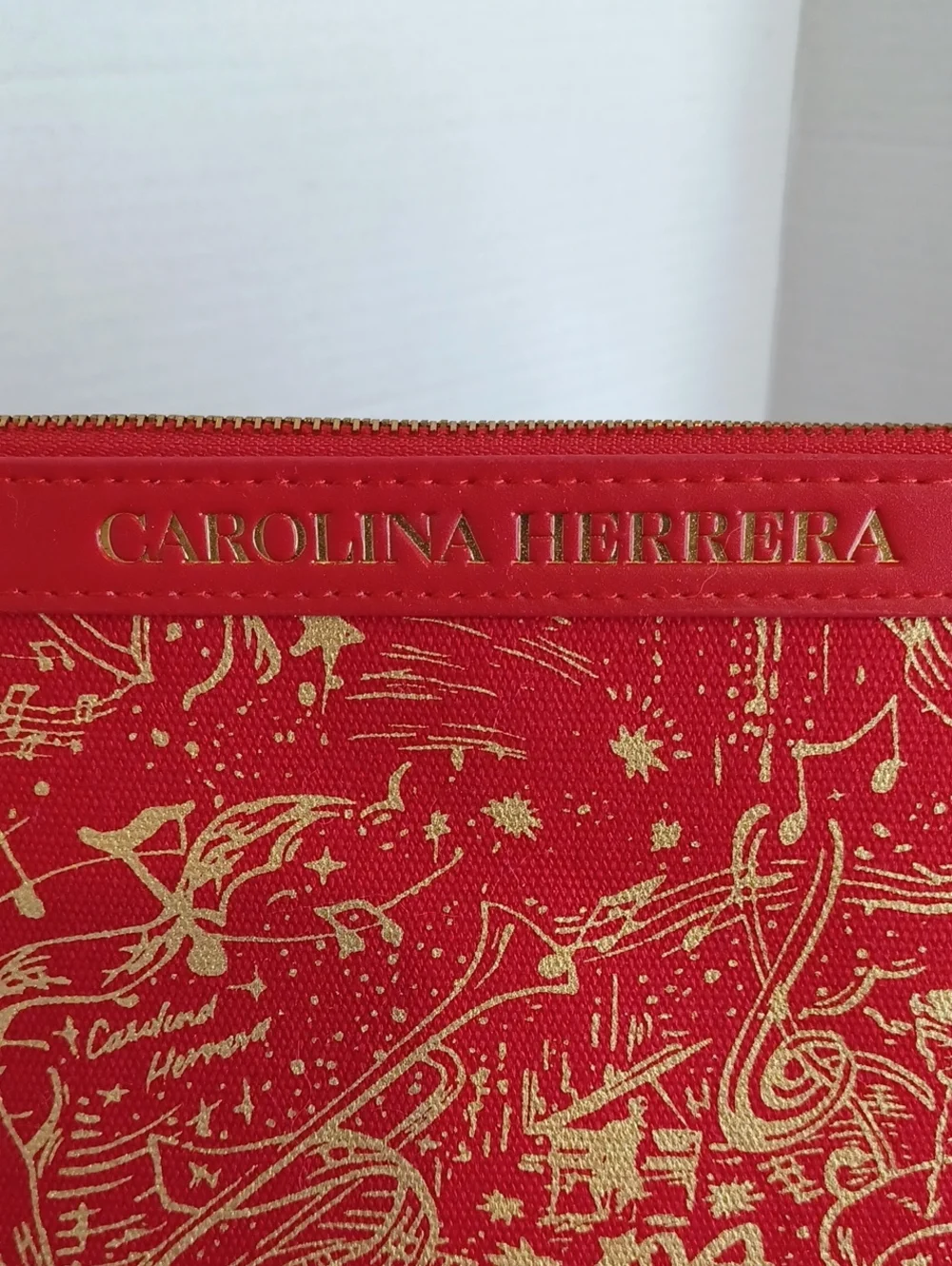 Carolina Herrera Red Zippered Cosmetic Pouch with Gold Musical Print NWOT